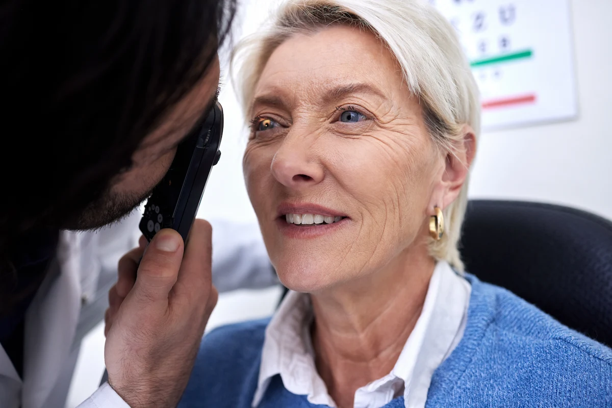 senior receiving eye exam in optometrist office